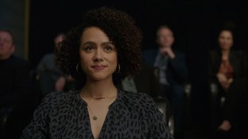 Movie still from “Die Hart” (2023), directed by Eric Appel – A person wearing a leopard print shirt; Close Up shot, Over the shoulder angle