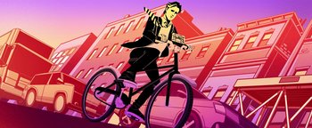 Movie still from “Die in a Gunfight” (2021), directed by Collin Schiffli – A man riding a bike down a street with cars in the background; Wide shot, Low angle