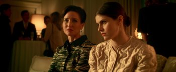 Movie still from “Die in a Gunfight” (2021), directed by Collin Schiffli – A woman and a woman sitting next to each other in a room; Close Up shot, Low angle