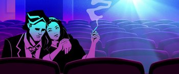 Movie still from “Die in a Gunfight” (2021), directed by Collin Schiffli – A woman sitting in a movie theater holding a cigarette in her hand; Medium shot, Low angle
