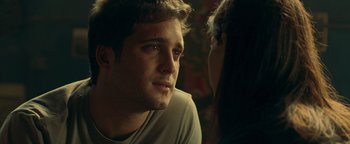 Movie still from “Die in a Gunfight” (2021), directed by Collin Schiffli – A man and a woman are talking to each other; Close Up shot, Over the shoulder angle