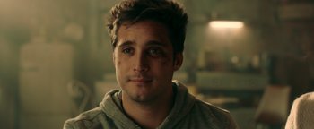 Movie still from “Die in a Gunfight” (2021), directed by Collin Schiffli – A person wearing a hooded sweatshirt; Close Up shot, Over the shoulder angle