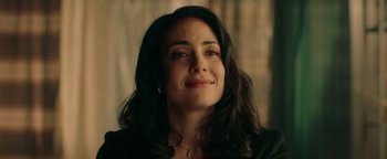 Movie still from “Die in a Gunfight” (2021), directed by Collin Schiffli – A person with long black hair; Close Up shot, Over the shoulder angle