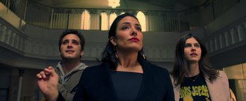 Movie still from “Die in a Gunfight” (2021), directed by Collin Schiffli – A woman in black jacket looking up in a church; Close Up shot, Low angle