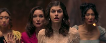 Movie still from “Die in a Gunfight” (2021), directed by Collin Schiffli – Two women standing next to each other in front of a wall; Close Up shot, Over the shoulder angle