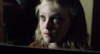 Movie still from “War of the Worlds” (2005), directed by Steven Spielberg – A young girl looking into a mirror in a dark room; Close Up shot, High angle