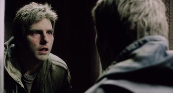 Movie still from “War of the Worlds” (2005), directed by Steven Spielberg – A man looking at himself in the mirror; Close Up shot, Over the shoulder angle