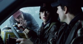 Movie still from “War of the Worlds” (2005), directed by Steven Spielberg – A group of people sitting in a car; Medium shot, Over the shoulder angle