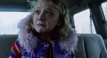 Movie still from “War of the Worlds” (2005), directed by Steven Spielberg – A little girl sitting in the back of a car; Close Up shot, High angle
