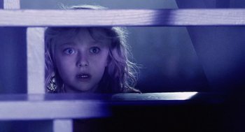 Movie still from “War of the Worlds” (2005), directed by Steven Spielberg – A young girl looking through a wooden fence; Close Up shot, Over the shoulder angle