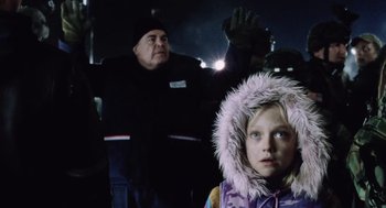 Movie still from “War of the Worlds” (2005), directed by Steven Spielberg – A young girl wearing a pink coat and a man in a black jacket; Close Up shot, Low angle