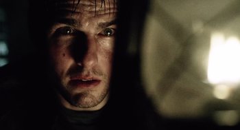 Movie still from “War of the Worlds” (2005), directed by Steven Spielberg – A man's face in the dark; Close Up shot, Over the shoulder angle