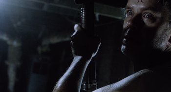 Movie still from “War of the Worlds” (2005), directed by Steven Spielberg – A person holding a wrench; Close Up shot, Low angle