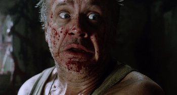 Movie still from “War of the Worlds” (2005), directed by Steven Spielberg – A person with blood all over his face; Close Up shot, Low angle