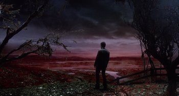Movie still from “War of the Worlds” (2005), directed by Steven Spielberg – A man standing in front of a body of water; Extreme Wide shot, High angle