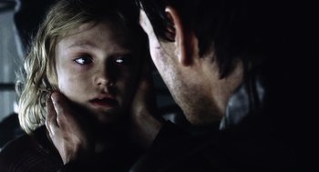 Movie still from “War of the Worlds” (2005), directed by Steven Spielberg – A man and a woman looking at each other in the dark; Close Up shot, Over the shoulder angle