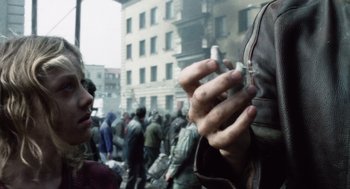 Movie still from “War of the Worlds” (2005), directed by Steven Spielberg – A man holding a cigarette in his hand; Close Up shot, Over the shoulder angle