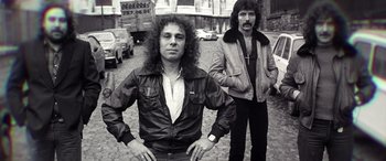 Two men standing next to each other on the street