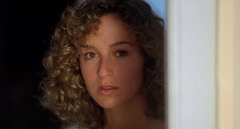 Movie still from “Dirty Dancing” (1987), directed by Emile Ardolino – A person with curly brown hair; Close Up shot, Low angle