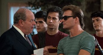 Movie still from “Dirty Dancing” (1987), directed by Emile Ardolino – A group of men standing next to each other; Close Up shot, Over the shoulder angle