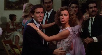 Movie still from “Dirty Dancing” (1987), directed by Emile Ardolino – A man and a woman dancing in front of other people; Medium shot, Low angle