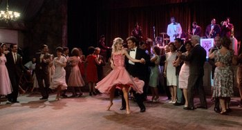 Movie still from “Dirty Dancing” (1987), directed by Emile Ardolino – A man and a woman dancing in front of a crowd; Wide shot, Low angle
