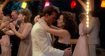 Movie still from “Dirty Dancing” (1987), directed by Emile Ardolino – A man and a woman dancing together at an event; Medium shot, Over the shoulder angle