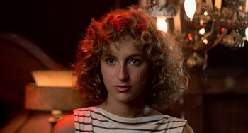 Movie still from “Dirty Dancing” (1987), directed by Emile Ardolino – A person with curly blonde hair; Close Up shot, Low angle