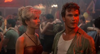 Movie still from “Dirty Dancing” (1987), directed by Emile Ardolino – A man and a woman standing next to each other in a room; Close Up shot, Over the shoulder angle