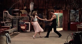 Movie still from “Dirty Dancing” (1987), directed by Emile Ardolino – A man and a woman dancing on a dance floor; Wide shot, Low angle