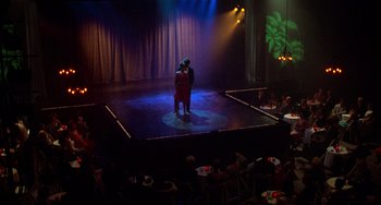 Movie still from “Dirty Dancing” (1987), directed by Emile Ardolino – A couple of people standing on top of a stage; Extreme Wide shot, High angle