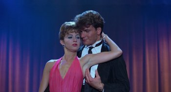 Movie still from “Dirty Dancing” (1987), directed by Emile Ardolino – A man and a woman are dancing on stage; Medium shot, Low angle