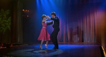 Movie still from “Dirty Dancing” (1987), directed by Emile Ardolino – A man and a woman are dancing on a stage; Wide shot, Low angle