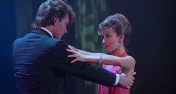 Movie still from “Dirty Dancing” (1987), directed by Emile Ardolino – A man and a woman dancing on a stage; Medium shot, Low angle
