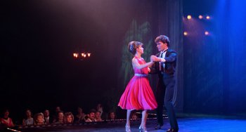 Movie still from “Dirty Dancing” (1987), directed by Emile Ardolino – A man and a woman dancing on a stage; Wide shot, Low angle