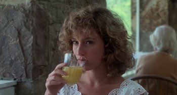 Movie still from “Dirty Dancing” (1987), directed by Emile Ardolino – A woman drinking a glass of orange juice; Close Up shot, Low angle