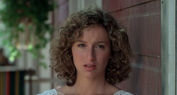 Movie still from “Dirty Dancing” (1987), directed by Emile Ardolino – A person with curly brown hair; Close Up shot, Over the shoulder angle