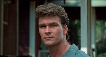 Movie still from “Dirty Dancing” (1987), directed by Emile Ardolino – A person wearing a blue shirt; Close Up shot, Low angle