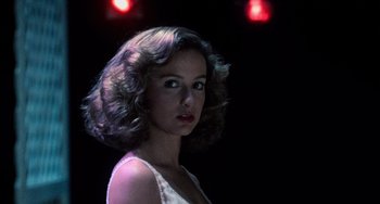 Movie still from “Dirty Dancing” (1987), directed by Emile Ardolino – A woman in a white top is in a dark room; Close Up shot, Low angle