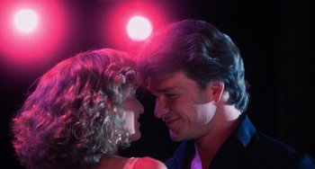 Movie still from “Dirty Dancing” (1987), directed by Emile Ardolino – A man and a woman dancing in front of a red light; Close Up shot, Low angle