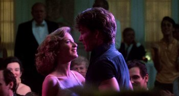 Movie still from “Dirty Dancing” (1987), directed by Emile Ardolino – A man and a woman dancing together in a crowd; Close Up shot, Low angle