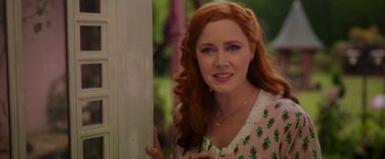Movie still from “Disenchanted” (2022), directed by Adam Shankman – A woman with long red hair wearing a white dress; Close Up shot, Over the shoulder angle