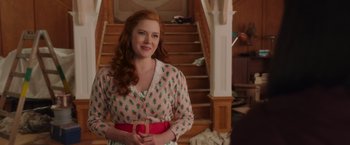 Movie still from “Disenchanted” (2022), directed by Adam Shankman – A woman with red curly hair wearing a pink dress; Medium shot, Over the shoulder angle