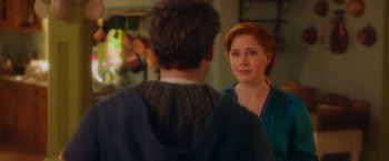 Movie still from “Disenchanted” (2022), directed by Adam Shankman – A man and a woman standing next to each other in a room; Close Up shot, Over the shoulder angle