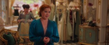 Movie still from “Disenchanted” (2022), directed by Adam Shankman – A woman standing in front of a bunch of dresses; Medium shot, Over the shoulder angle