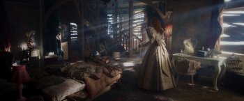 Movie still from “Disenchanted” (2022), directed by Adam Shankman – A woman in a white dress standing in front of a bed; Wide shot, High angle