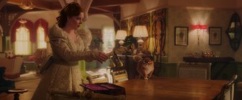 Movie still from “Disenchanted” (2022), directed by Adam Shankman – A woman in a white dress is holding a cat; Medium shot, Over the shoulder angle