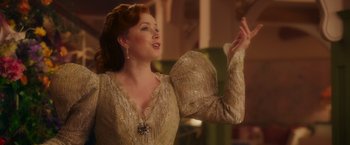 Movie still from “Disenchanted” (2022), directed by Adam Shankman – A woman in a dress is singing; Medium shot, Low angle