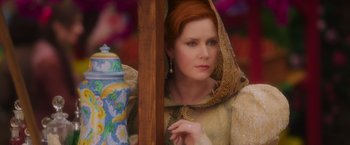 Movie still from “Disenchanted” (2022), directed by Adam Shankman – A woman with red hair wearing a gold dress; Close Up shot, Over the shoulder angle