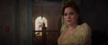 Movie still from “Disenchanted” (2022), directed by Adam Shankman – A woman with red hair wearing a yellow dress; Close Up shot, Over the shoulder angle